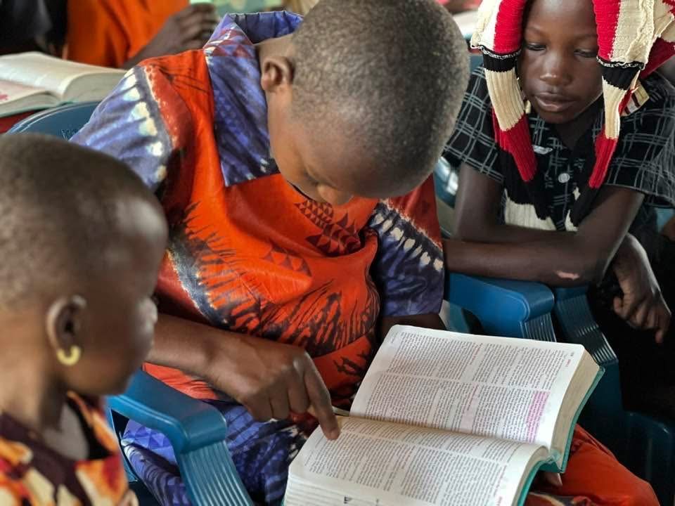 Children reading the Bible together