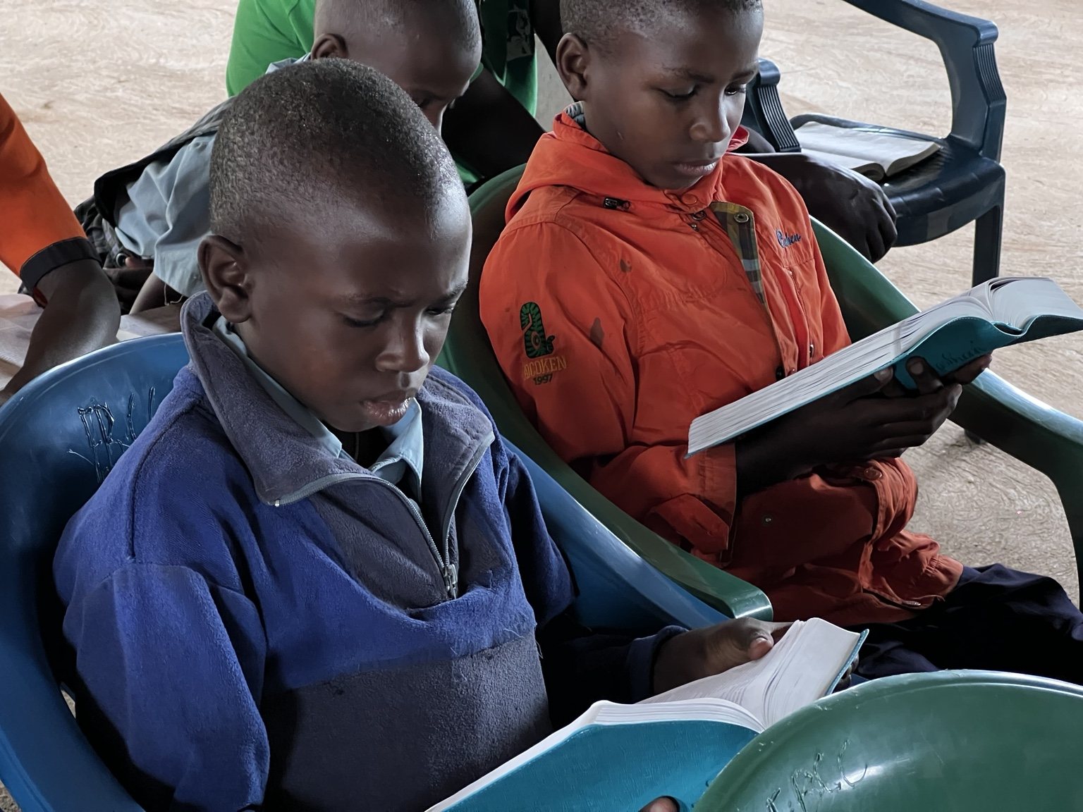 Children reading in chairs